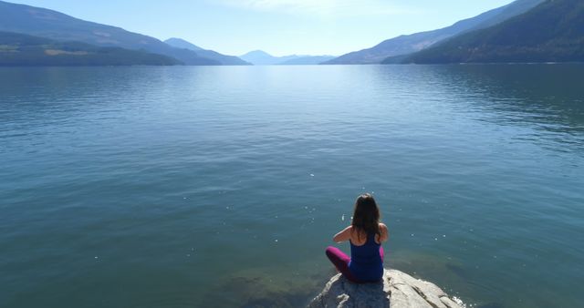 Woman Meditating by Serene Mountain Lake at Sunrise - Download Free Stock Images Pikwizard.com