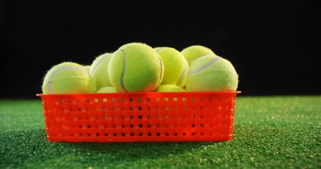 Basket of Bright Yellow Tennis Balls on Artificial Grass - Download Free Stock Images Pikwizard.com