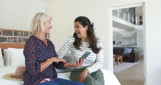 Two Mature Women Sharing Laughter Poses on Bed - Download Free Stock Images Pikwizard.com