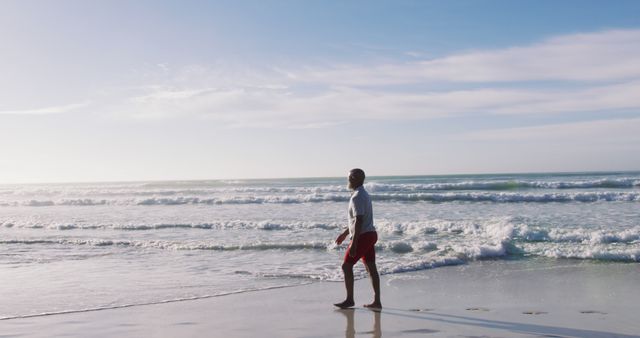 Senior african american man walking at the beach - Download Free Stock Photos Pikwizard.com