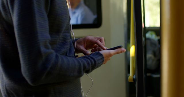 Person Texting on Mobile Phone While Riding Public Transport - Download Free Stock Images Pikwizard.com