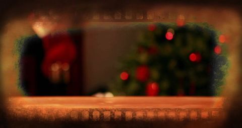Rustic wooden tabletop with blurred christmas tree bokeh and vintage filmstrip vignette