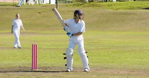Female Cricketer Batting on Sunny Cricket Field