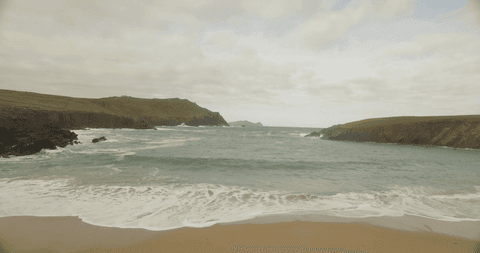 transparent ocean view on overcast day along rocky coastline - Download Free Stock Videos Pikwizard.com