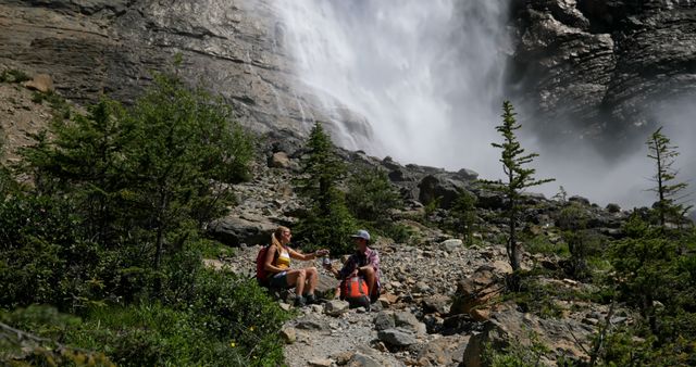 Hikers Resting Near Waterfall in Mountainous Landscape - Download Free Stock Images Pikwizard.com