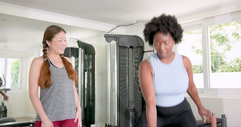 Diverse Women Engaged in Fitness Training with Enthusiastic Communication