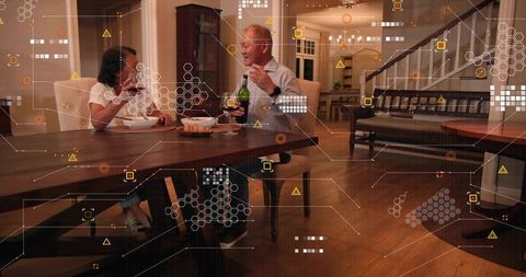 Mature couple sharing dinner and wine at home with augmented reality digital overlay