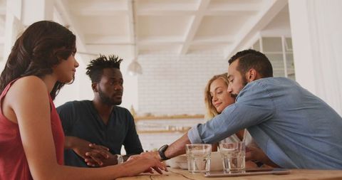 Diverse friends playing cards relaxing weekend gathering