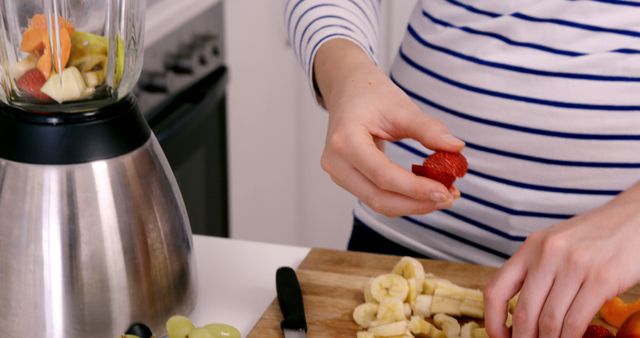 Person Preparing Fresh Fruit Smoothie in Kitchen - Download Free Stock Images Pikwizard.com