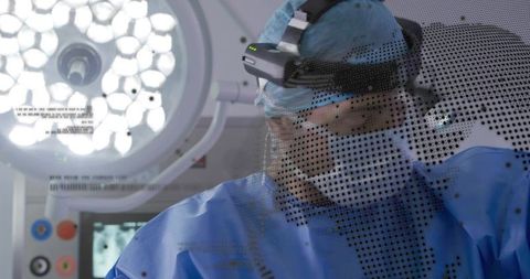 Surgeon wearing surgical loupe and led headlight performing precise operation in or