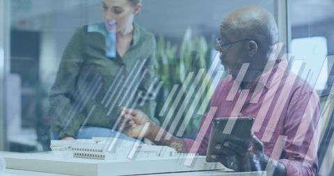 Collaborative Business Meeting with Diverse Professionals Analyzing Financial Data