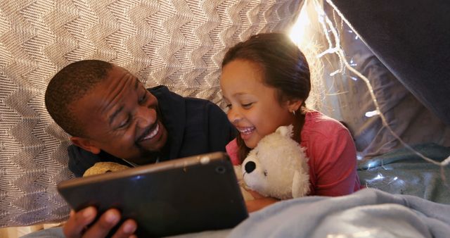 Happy Father and Daughter Reading on Tablet in Homemade Fort - Download Free Stock Images Pikwizard.com