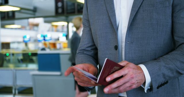 Businessman Holding Passport in Airport Terminal - Download Free Stock Images Pikwizard.com