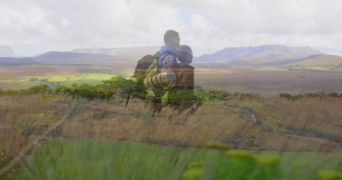Couple embracing nature from hilltop vantage point on a hiking adventure