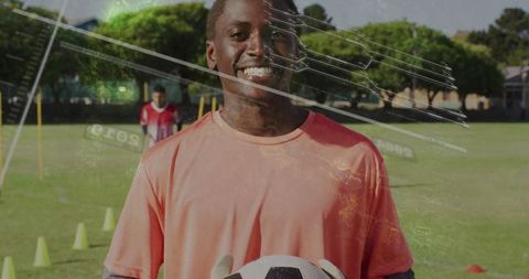 Youth Soccer Goalkeeper Holding Ball on Field