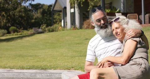 Senior Couple Enjoying Leisurely Day Outdoors on Green Lawn