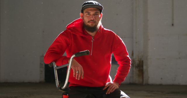 Confident Young Man with Beard Sitting on Bicycle in Urban Setting - Download Free Stock Images Pikwizard.com