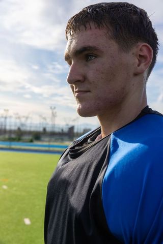 Teenage athlete in blue jersey on sports field
