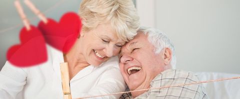 Joyful elderly couple sharing affectionate moment with heart decor