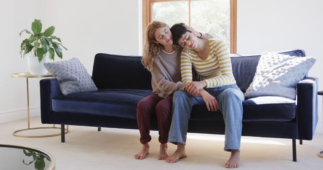 Comforting Friends Relaxing on Couch in Light-Filled Living Room - Download Free Stock Images Pikwizard.com