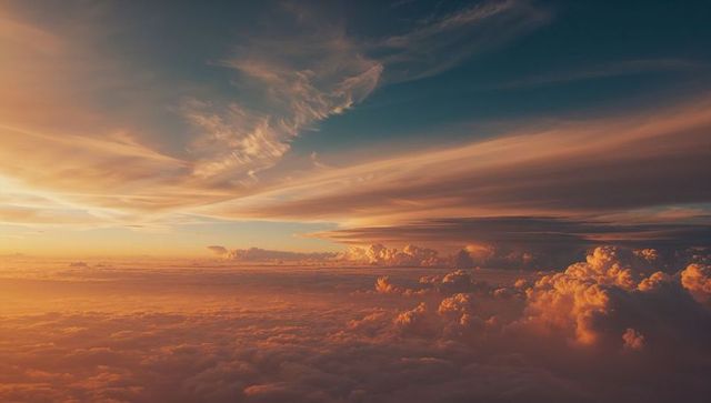 Sunlit cloudscape above horizon at sunset