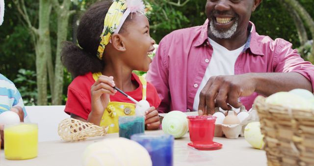 Image of happy african american grandfather and grandchildren painting easter eggs in garden - Download Free Stock Photos Pikwizard.com