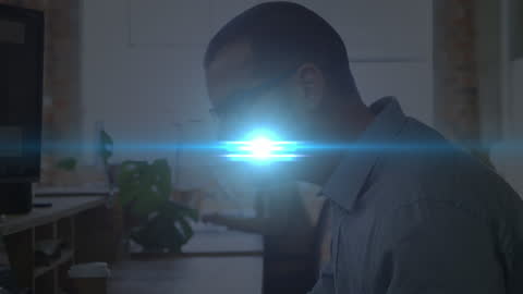 Man Working at Office Desk with Glowing Light Effect
