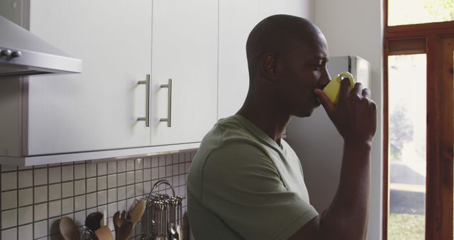 Young Man Drinking Coffee in Modern Kitchen in Morning Light - Download Free Stock Images Pikwizard.com