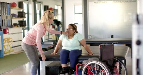 Physical Therapy Session with Woman in Wheelchair and Therapist