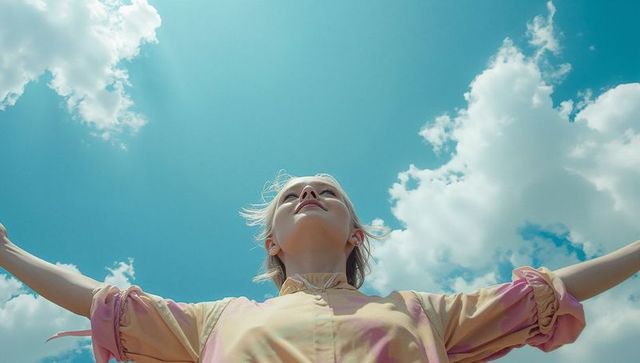 Woman Embracing Fresh Air Under Vibrant Blue Sky