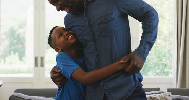 Warm Hug Between Father and Son in Living Room - Download Free Stock Images Pikwizard.com