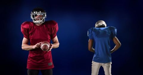 Diverse american football players against dark background