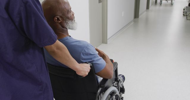 Healthcare Worker Assisting Elderly Patient in Wheelchair in Hospital Corridor - Download Free Stock Images Pikwizard.com