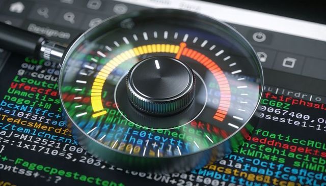 Magnifying glass revealing control dial over colorful programming code for cybersecurity concept