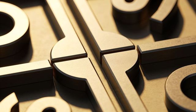 Bronze geometric connector macro showing interlocking rings, machined seams, warm metal