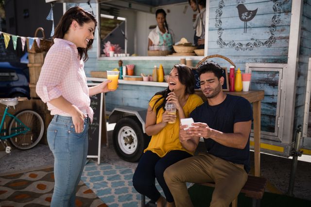 Smiling friends interacting with each other in food truck van