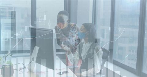 Businesswomen Collaborating with Financial Data in Office Amid Pandemic