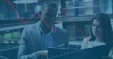 Business Professionals Analyzing Financial Charts with Modern Technology