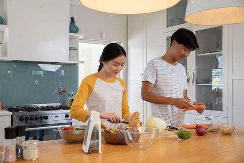 Asian Couple Preparing Healthy Salad in Modern Home Kitchen