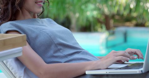 Relaxed Woman Working on Laptop by Poolside - Download Free Stock Images Pikwizard.com