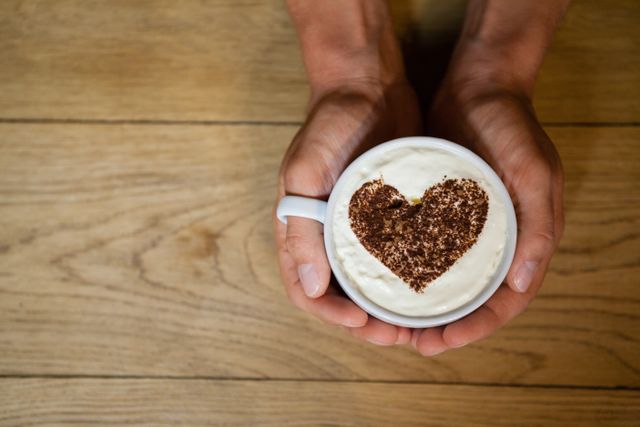 Hands Holding Coffee Cup with Heart-Shaped Frothy Art - Download Free Stock Photos Pikwizard.com