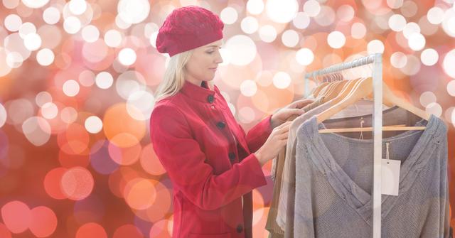 Woman wearing red sweater and beret choosing clothes from rack, set against a bokeh backdrop. Great for fashion retail promotions, winter clothing ads, and holiday sales.