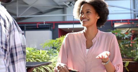 African American Worker Enjoying Conversation in Modern Office