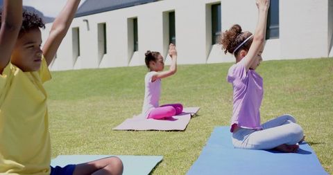 Children Practicing Yoga Outdoors on School Lawn