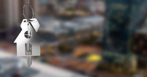 Silver House Keys Hanging with Blurry Cityscape Background