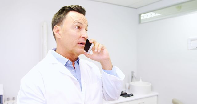 Male Doctor Talking on Smartphone in Modern Clinic - Download Free Stock Images Pikwizard.com