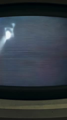 Vertical video showing CRT power spike causing bright streak over retro monitor scanlines and bezel