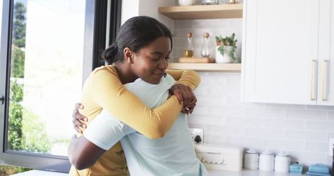 Smiling African American Couple Embracing in Their Modern Kitchen - Download Free Stock Images Pikwizard.com
