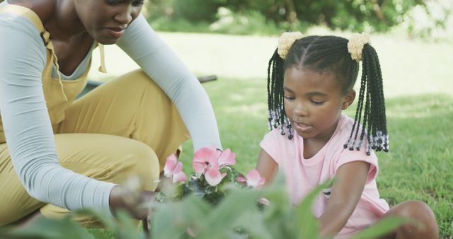 Mother and Daughter Planting Flowers in Garden on Sunny Day - Download Free Stock Images Pikwizard.com