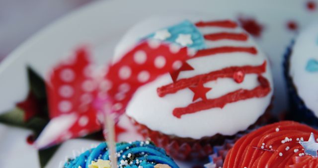 Image shows assorted cupcakes with red, white, and blue frosting, decorated with American flag designs and star toppings. Ideal for promoting 4th of July celebrations, Independence Day parties, and themed desserts in cookbooks or event planning materials.